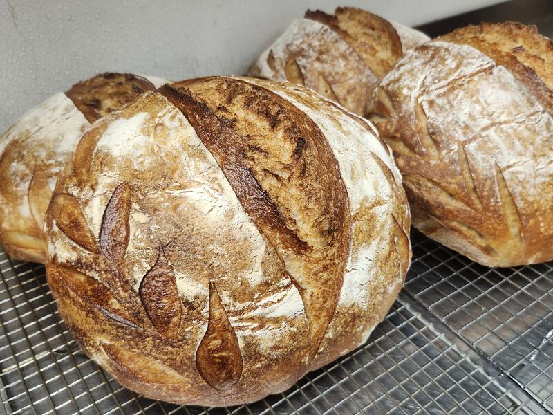 Three finished loaves cooling together