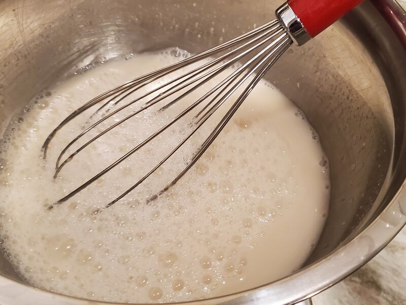 Starter whisked into water, loose and bubbling